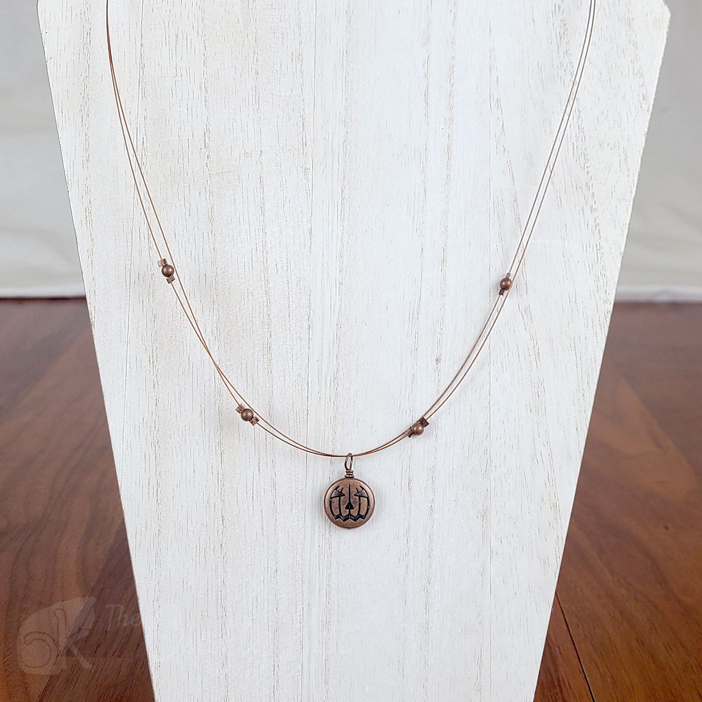 Tigertail necklace with simple round beads and jack o'lantern charms in antique copper