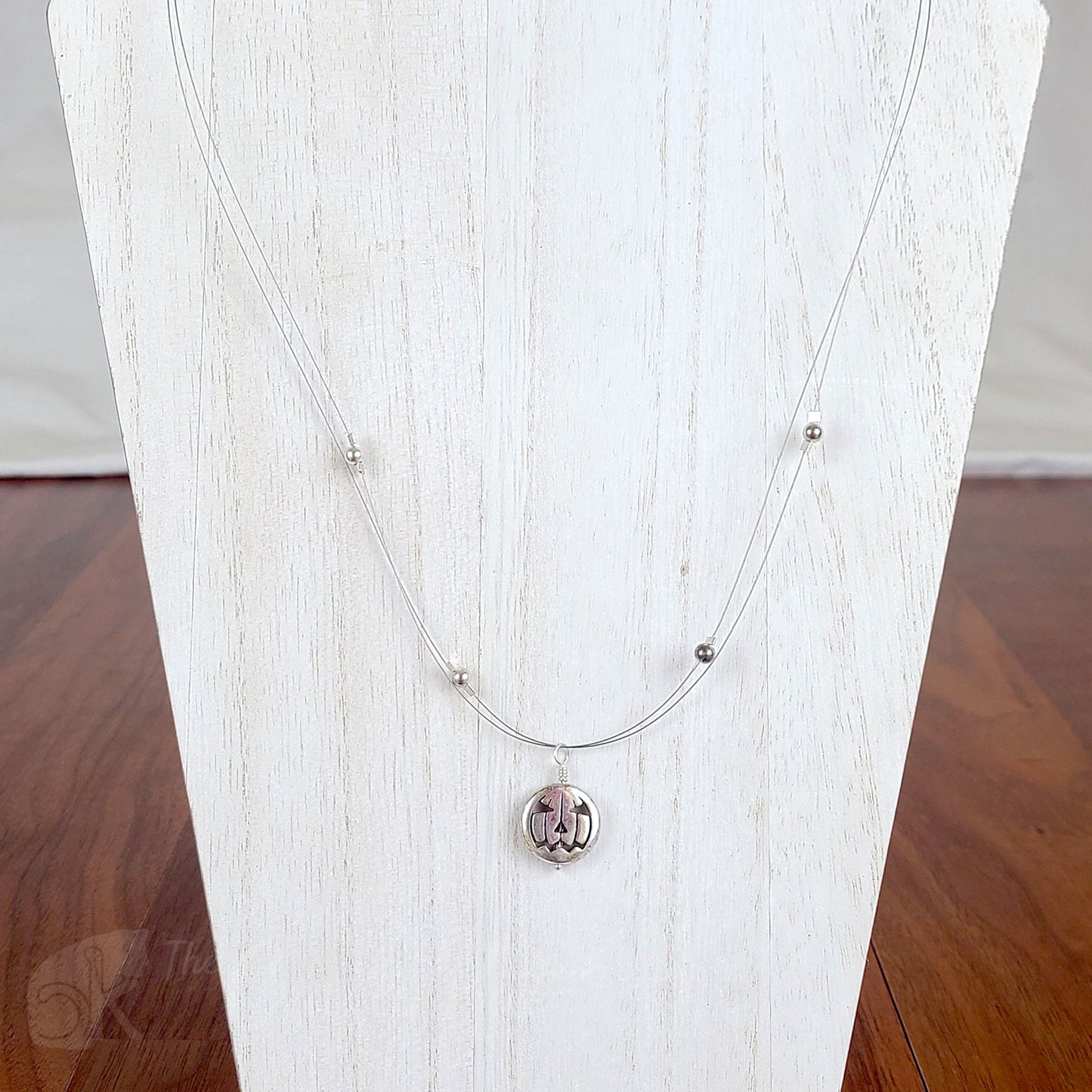 Tigertail necklace with simple round beads and jack o'lantern charms in antique silver