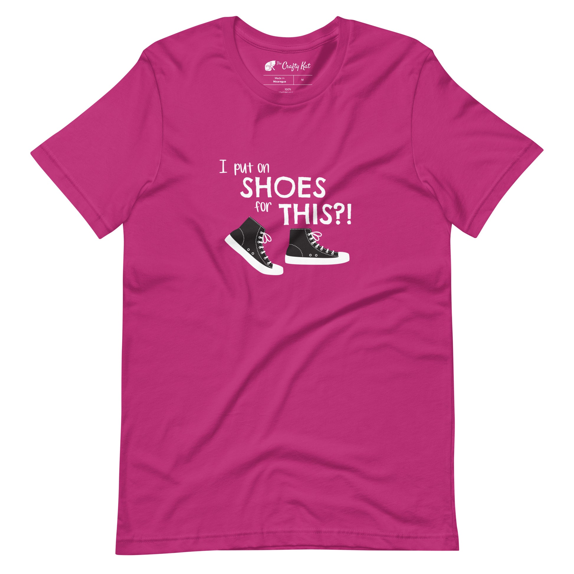 Berry (hot pink) t-shirt with graphic of black and white canvas "chuck" sneakers and text: "I put on SHOES for THIS?!"