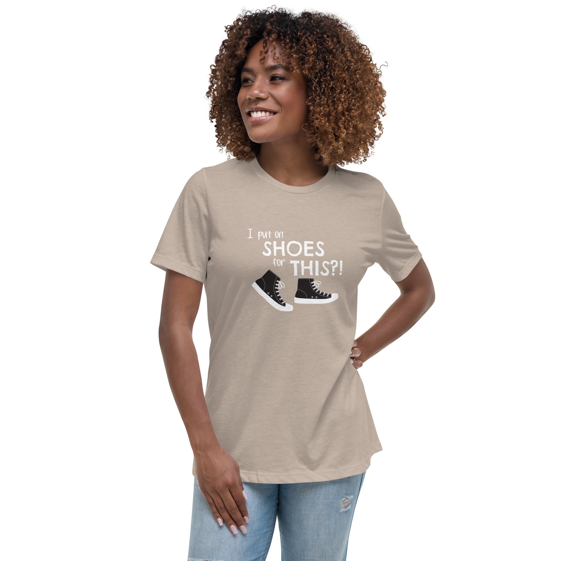 Model wearing Heather Stone women's relaxed fit t-shirt with graphic of black and white canvas "chuck" sneakers and text: "I put on SHOES for THIS?!"