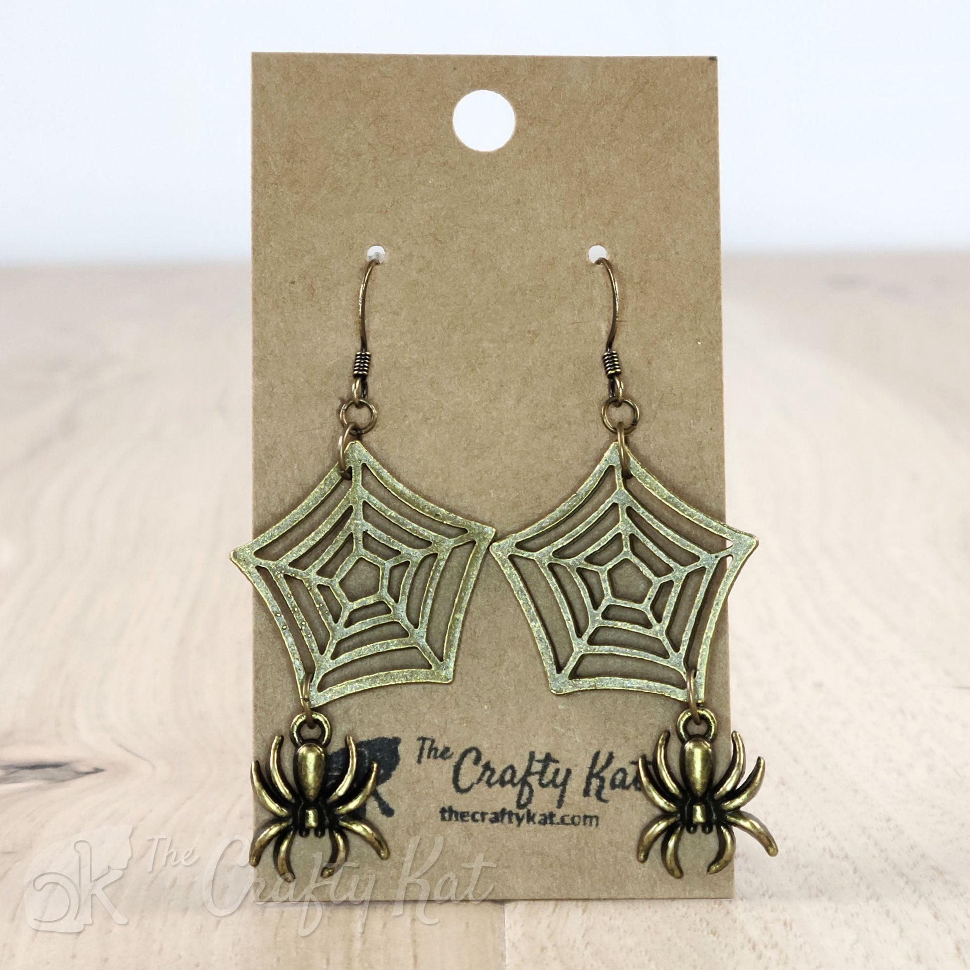 Drop earrings made of bronze webs and spiders.