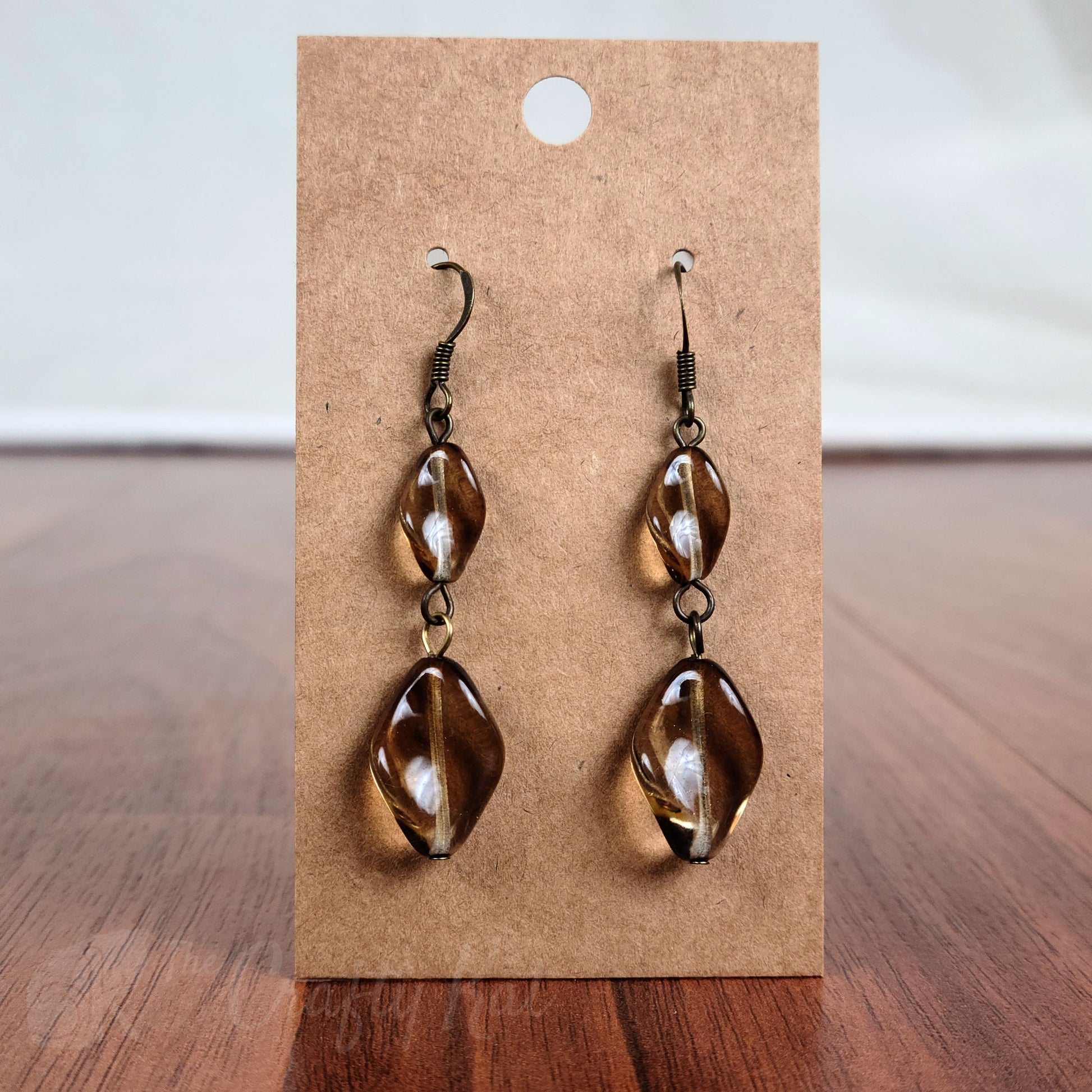 Tiered earrings made with translucent brown twisted glass beads on bronze fittings.
