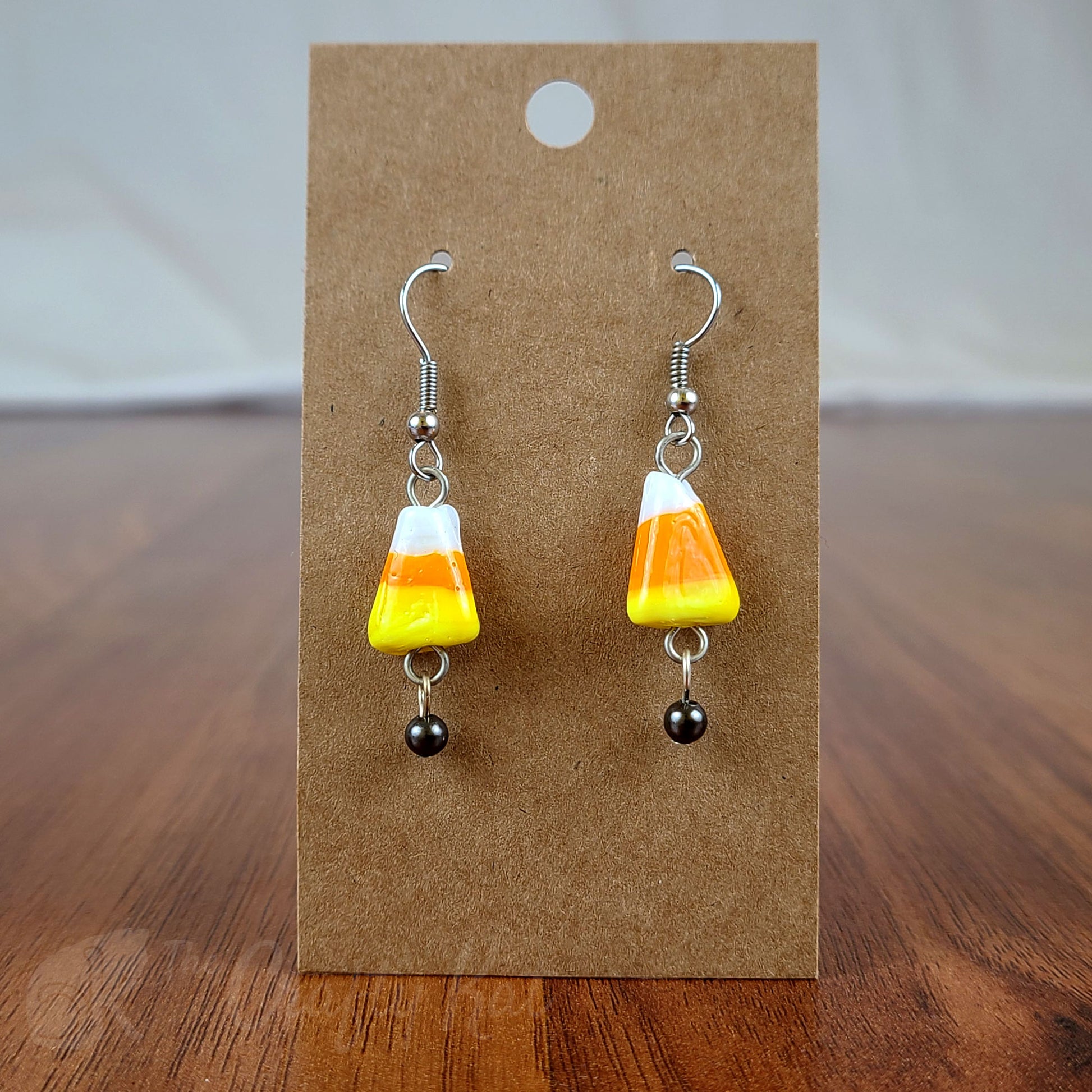 Lampwork glass orange, yellow, and white candy corn earrings with gunmetal and silver-plated base metal fittings