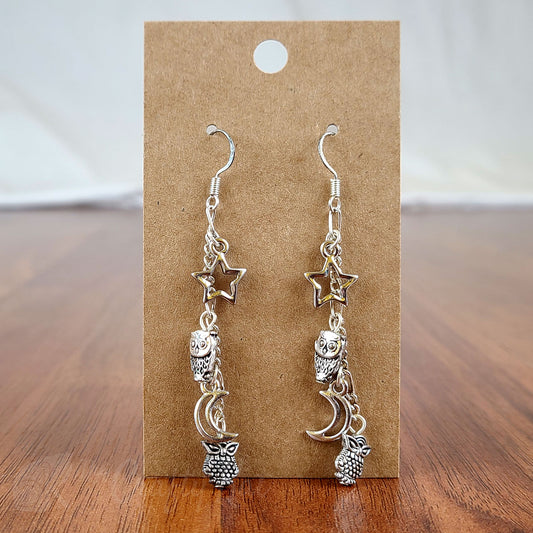 Cascading earrings made of silver-plated owls, stars, and crescent moons