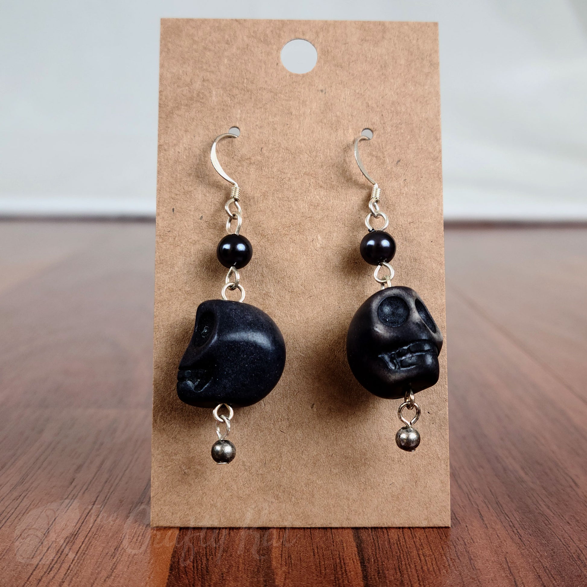 Black stone skull earrings with silver hardware