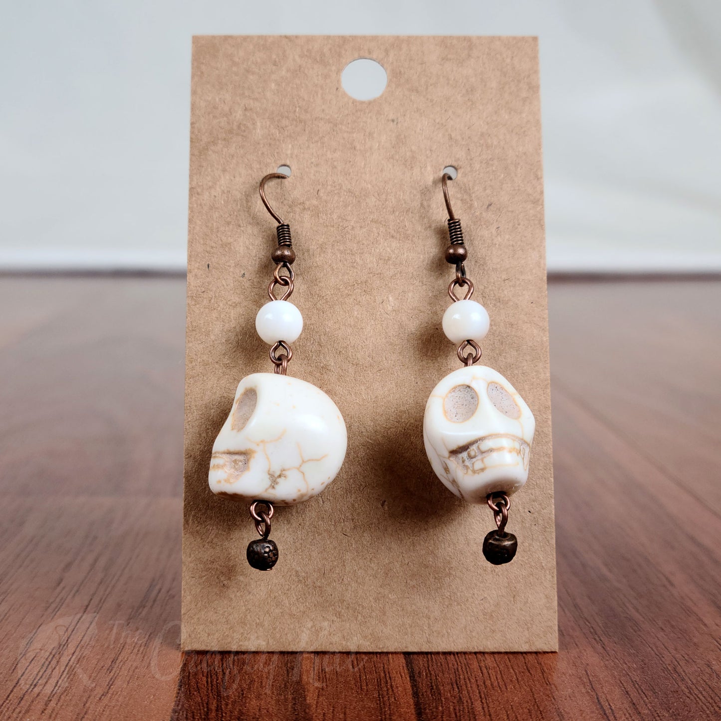 White stone skull earrings with antique copper hardware