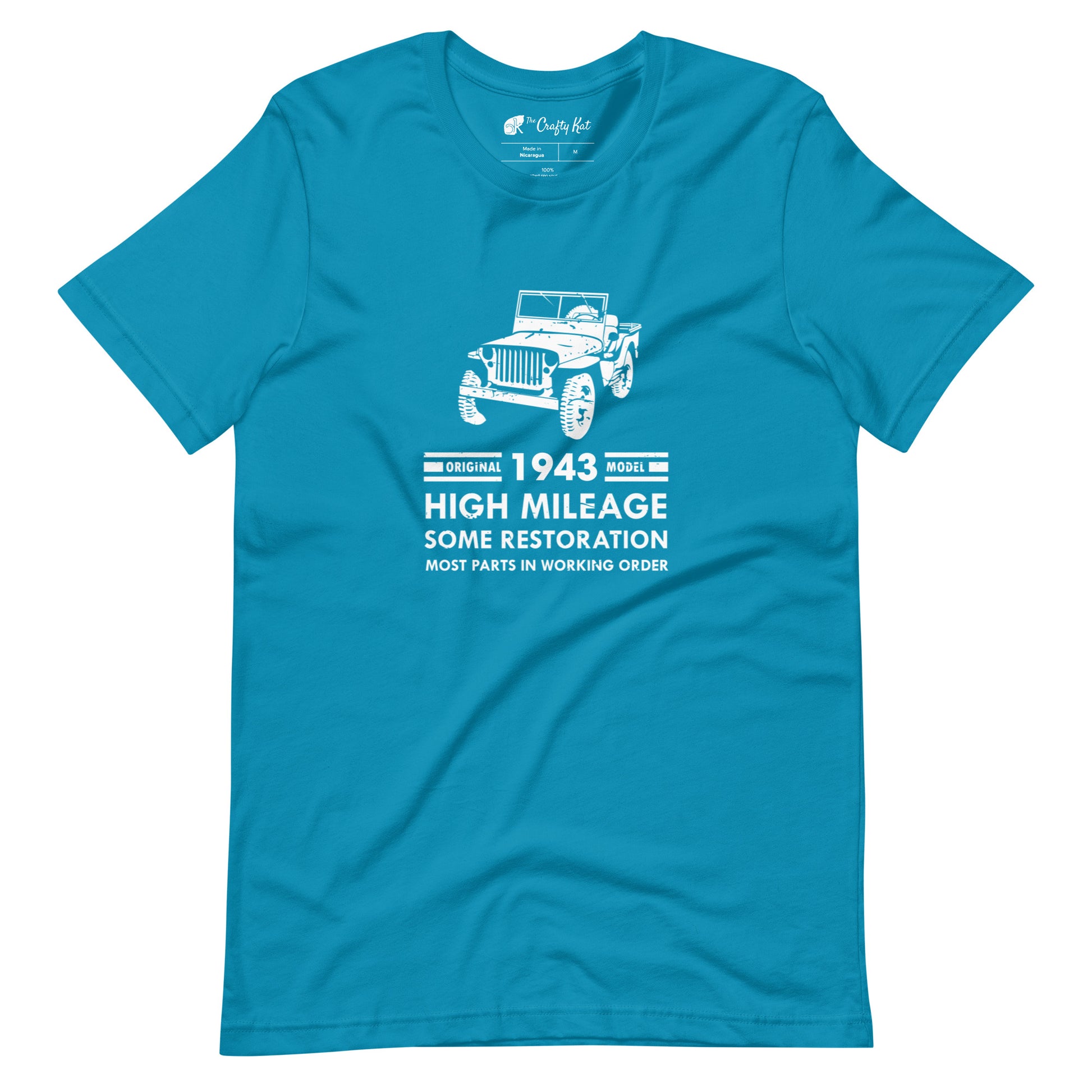 Aqua (cyan) t-shirt with distressed graphic of old military jeep and text "Original YEAR model HIGH MILEAGE some restoration MOST PARTS IN WORKING ORDER"