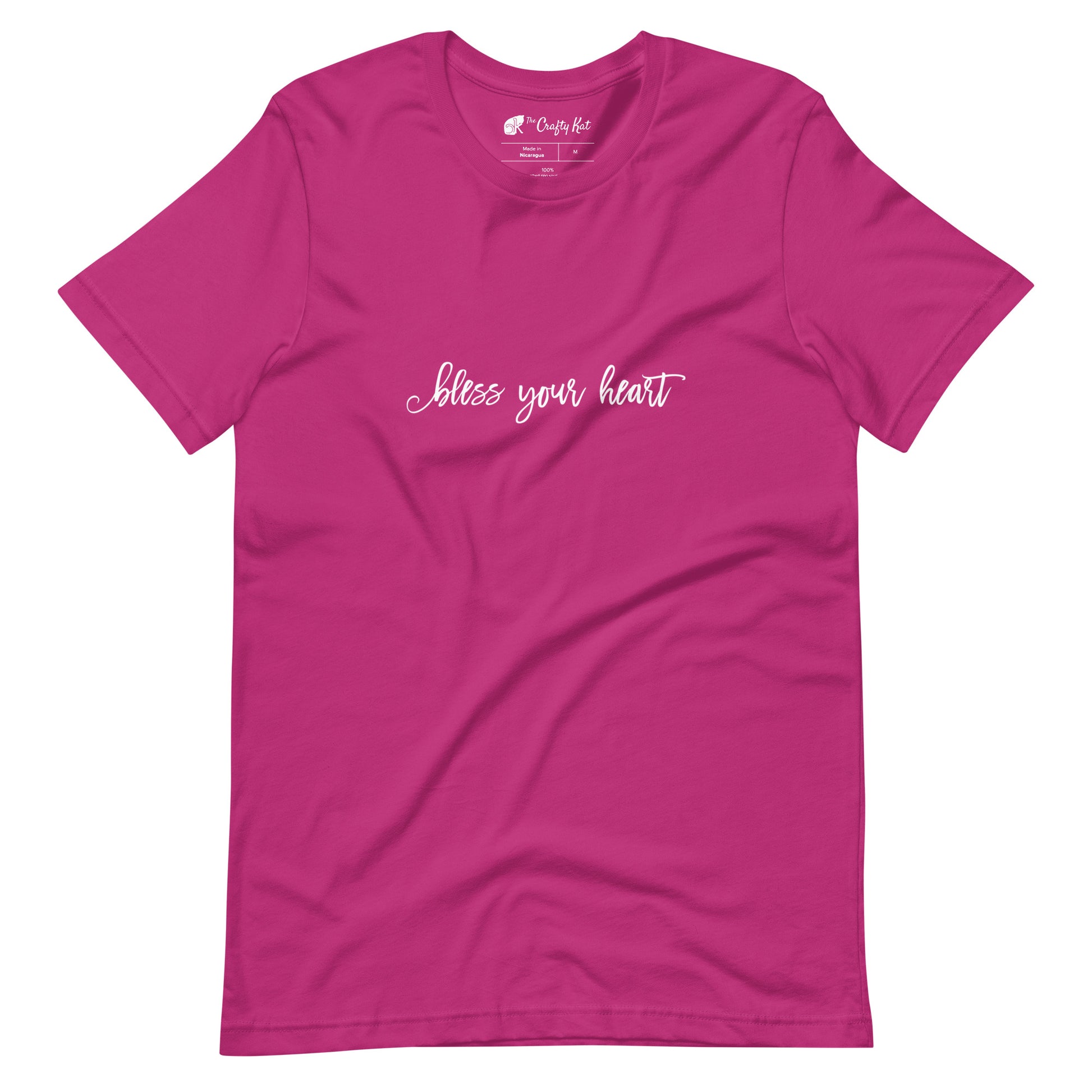 Berry (hot pink) t-shirt with white graphic in an excessively twee font: "bless your heart"