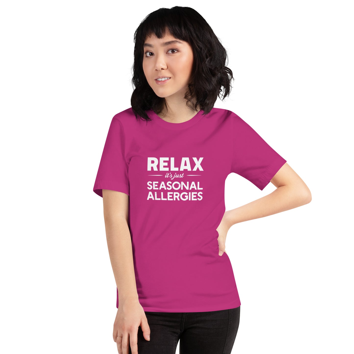 Model wearing Berry (hot pink) t-shirt with white graphic: "RELAX it's just SEASONAL ALLERGIES"