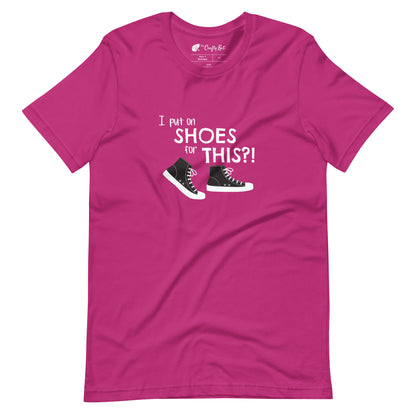 Berry (hot pink) t-shirt with graphic of black and white canvas "chuck" sneakers and text: "I put on SHOES for THIS?!"