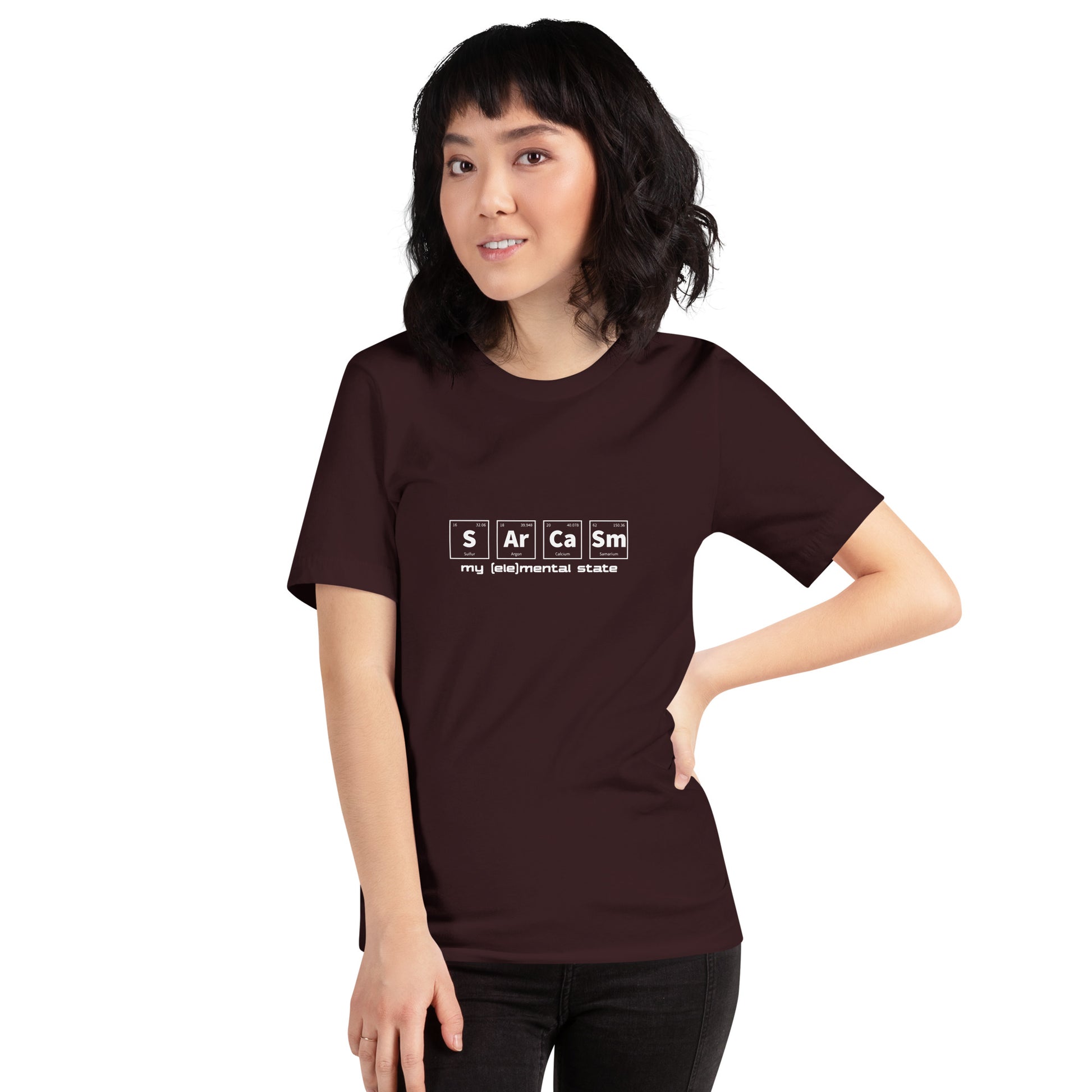 Model wearing Oxblood Black t-shirt with graphic of periodic table of elements symbols for Sulfur (S), Argon (Ar), Calcium (Ca), and Samarium (Sm) and text "my (ele)mental state"