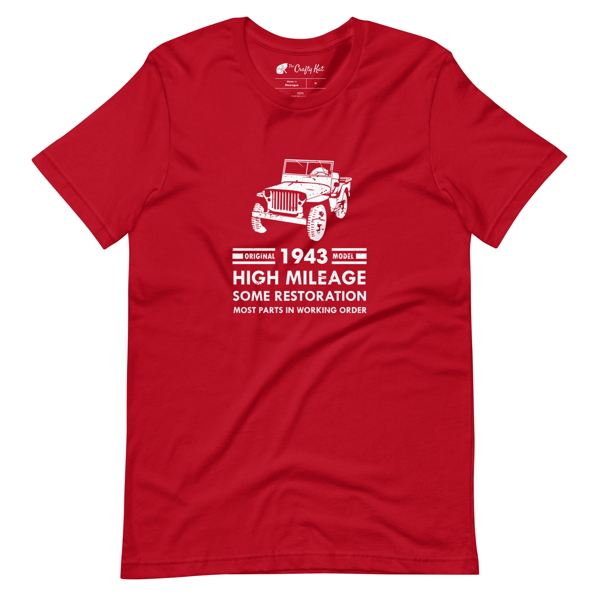 Red t-shirt with distressed graphic of old military jeep and text "Original YEAR model HIGH MILEAGE some restoration MOST PARTS IN WORKING ORDER"