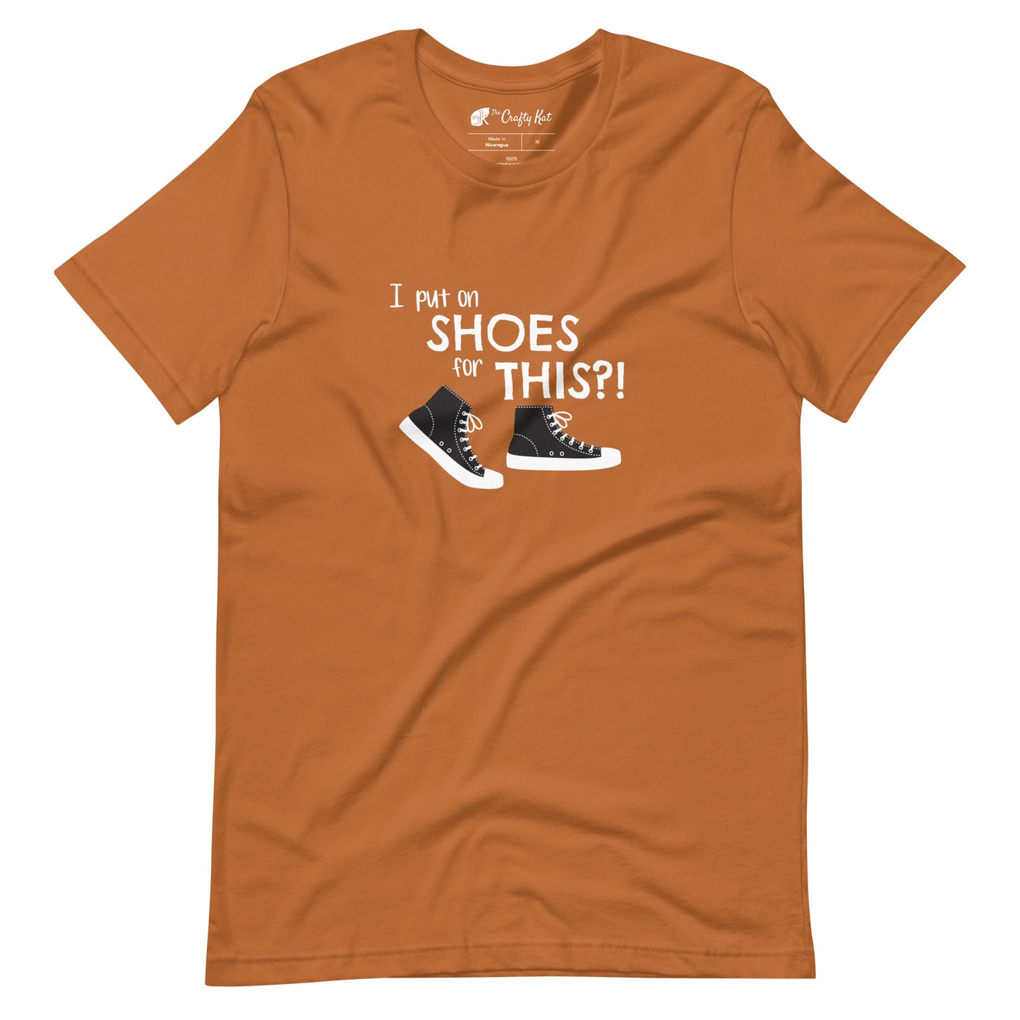 Toast (yellow orange) t-shirt with graphic of black and white canvas "chuck" sneakers and text: "I put on SHOES for THIS?!"