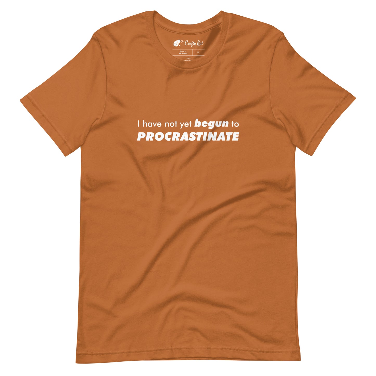 Toast (light orange) t-shirt with text graphic: "I have not yet BEGUN to PROCRASTINATE"