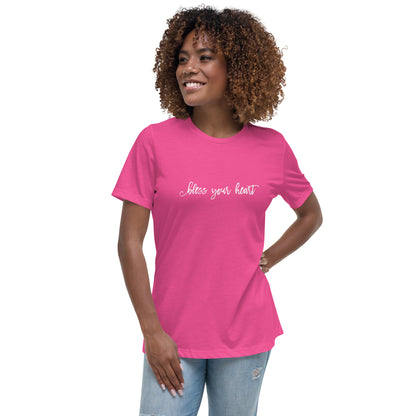 Model wearing Berry (hot pink) women's relaxed fit t-shirt with white graphic in an excessively twee font: "bless your heart"