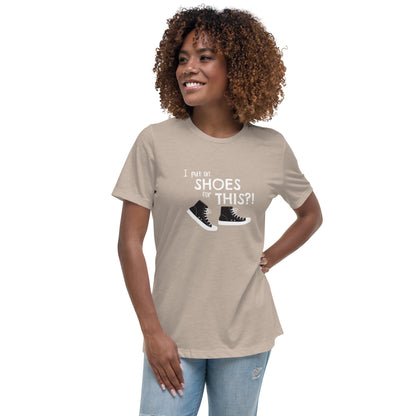 Model wearing Heather Stone women's relaxed fit t-shirt with graphic of black and white canvas "chuck" sneakers and text: "I put on SHOES for THIS?!"