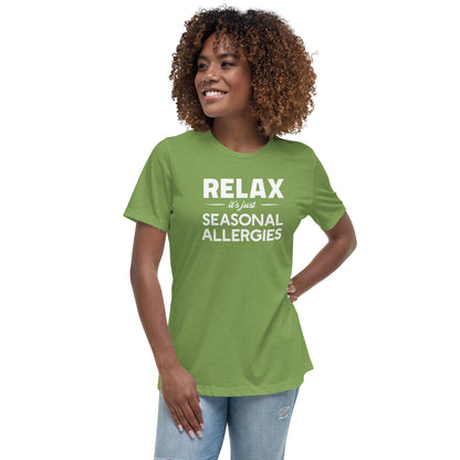 Model wearing Leaf green women's relaxed fit t-shirt with white graphic: "RELAX it's just SEASONAL ALLERGIES"