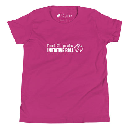 Berry (magenta) youth t-shirt with a graphic of a d20 (twenty-sided die) showing a roll of "1" and text: "I'm not LATE, I got a low INITIATIVE ROLL"