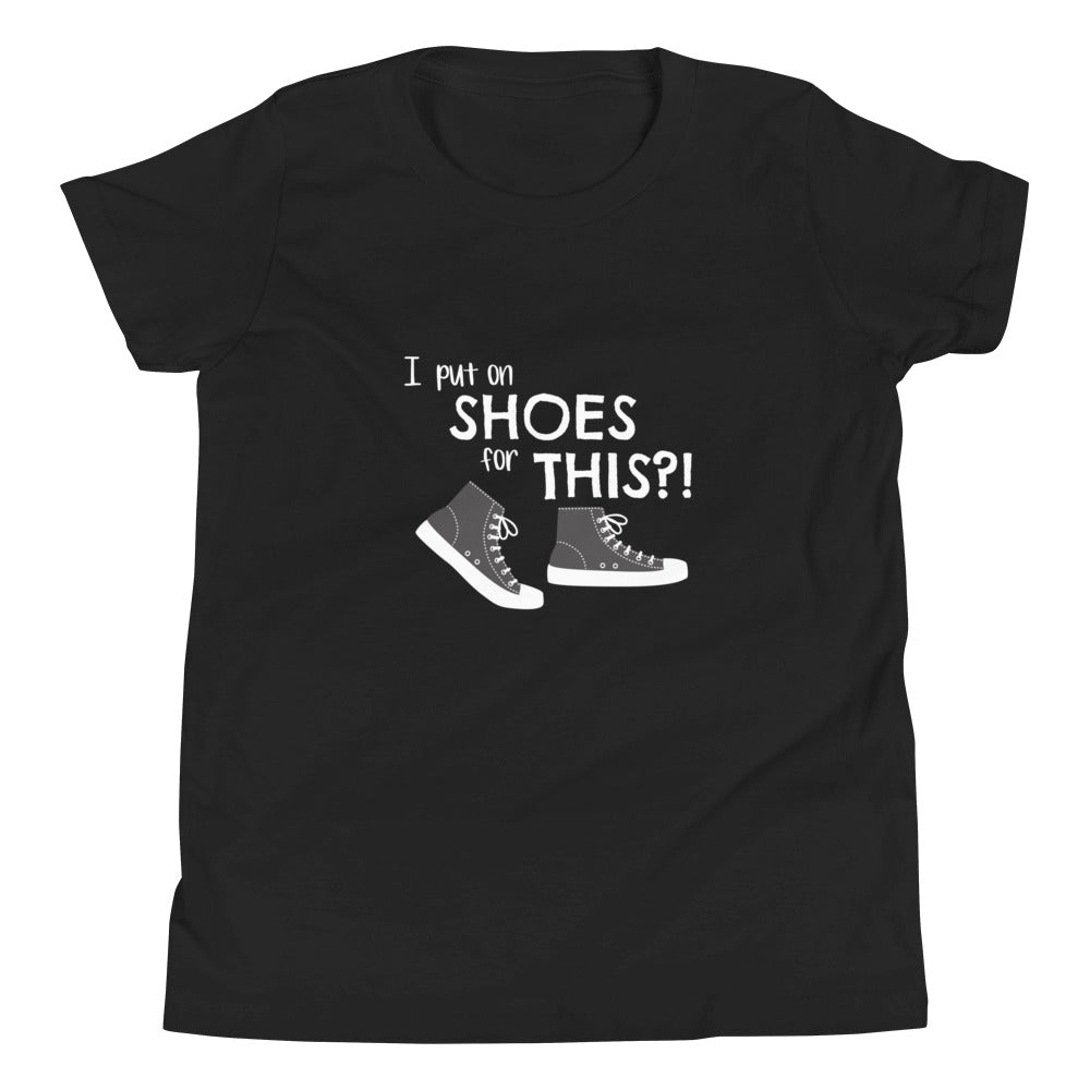 Black youth t-shirt with graphic of black and white canvas "chuck" sneakers and text: "I put on SHOES for THIS?!"