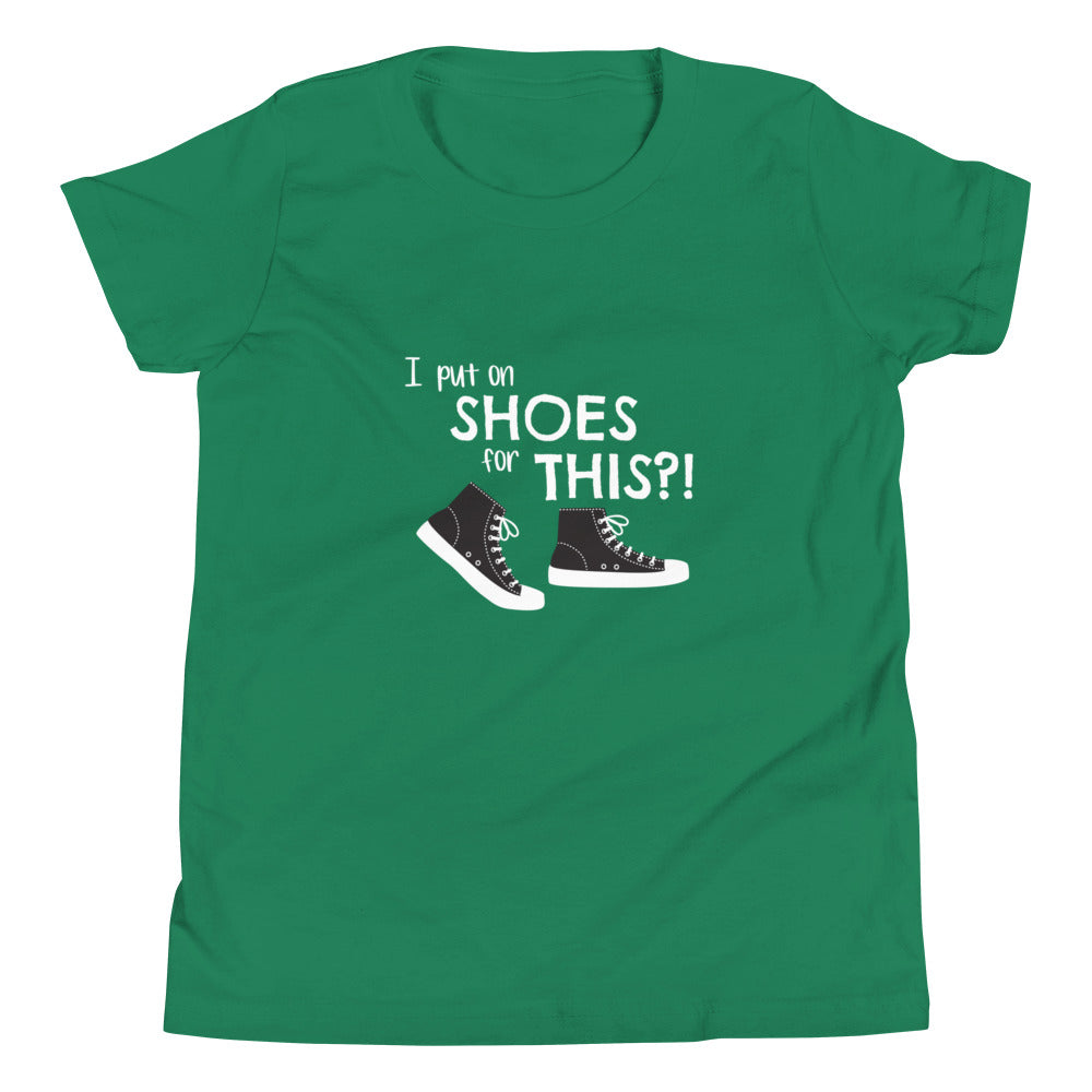 Kelly green youth t-shirt with graphic of black and white canvas "chuck" sneakers and text: "I put on SHOES for THIS?!"