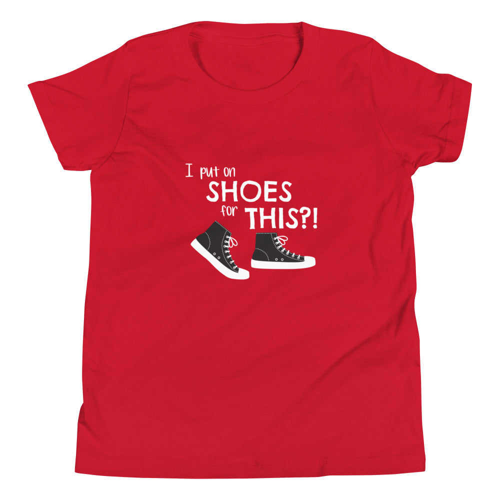 Red youth t-shirt with graphic of black and white canvas "chuck" sneakers and text: "I put on SHOES for THIS?!"