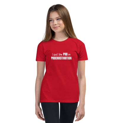 Young female model wearing red youth t-shirt with text graphic: "I put the PRO in PROCRASTINATION"