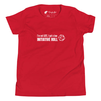 Red youth t-shirt with a graphic of a d20 (twenty-sided die) showing a roll of "1" and text: "I'm not LATE, I got a low INITIATIVE ROLL"