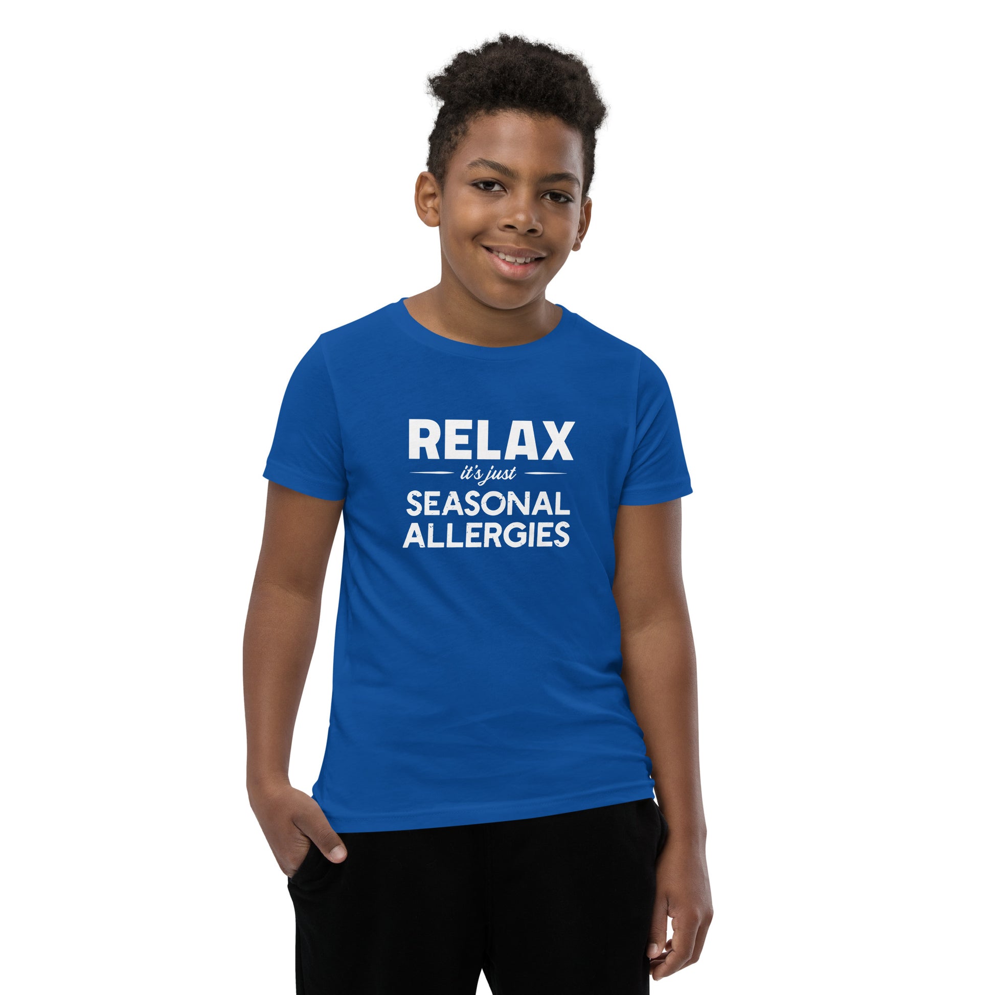 Model wearing True Royal blue youth t-shirt with white graphic: "RELAX it's just SEASONAL ALLERGIES"