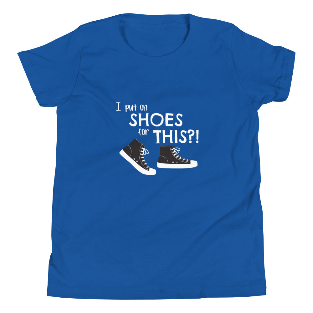 True Royal blue youth t-shirt with graphic of black and white canvas "chuck" sneakers and text: "I put on SHOES for THIS?!"